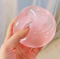 Pink squishy stress ball squeezed in hand